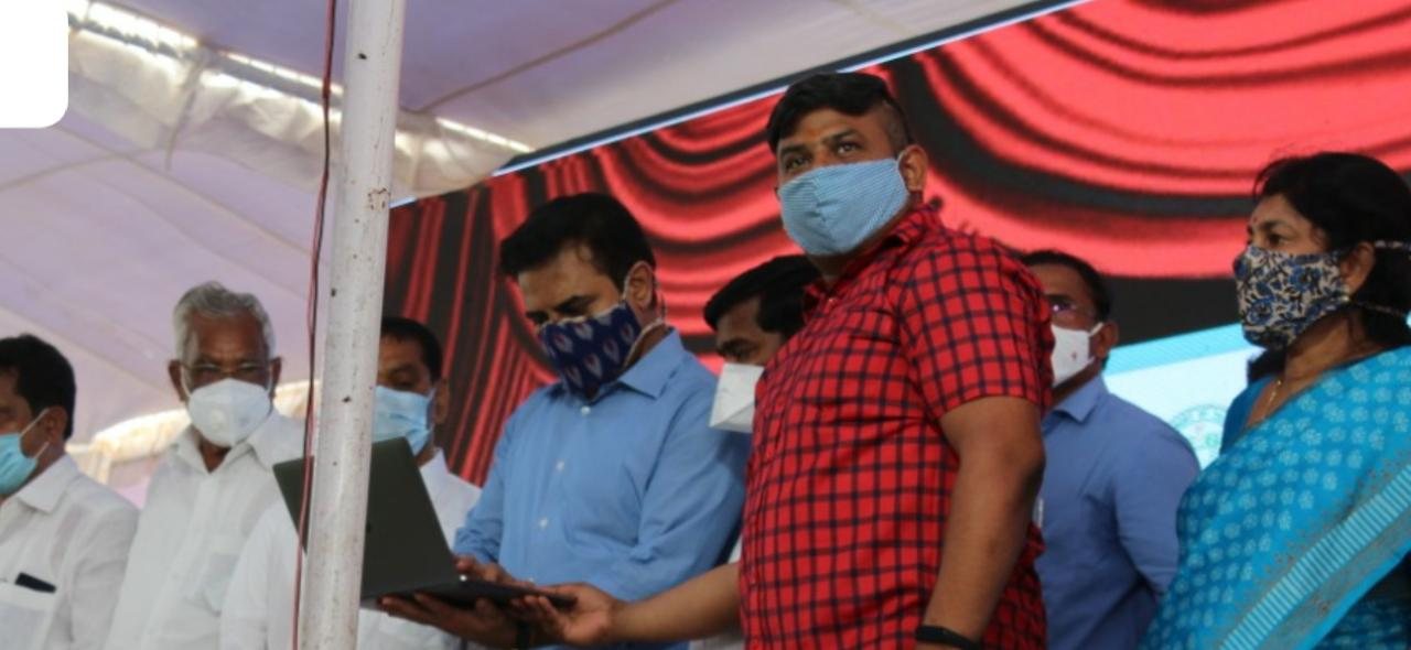 Hon’ble Minister for IT & MA&UD Sri K. T. Rama Rao launching the Pattana Pragathi Toilet Monitoring System, with the DWI.agency team on stage.